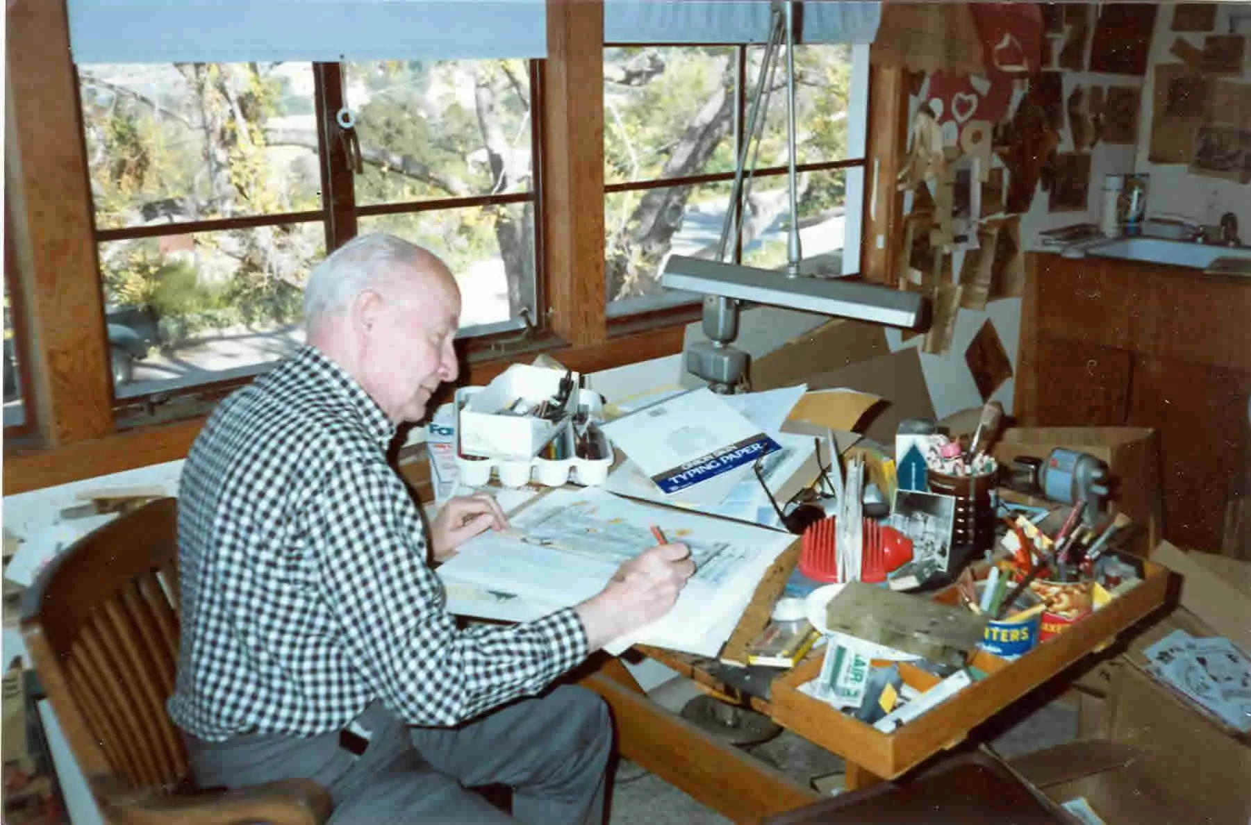 Bill Peet at his drawing board in his Studio City home studio, 1989