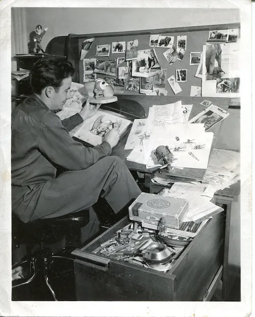 Publicity photograph of Bill Peet hamming it up as the designer of Dumbo