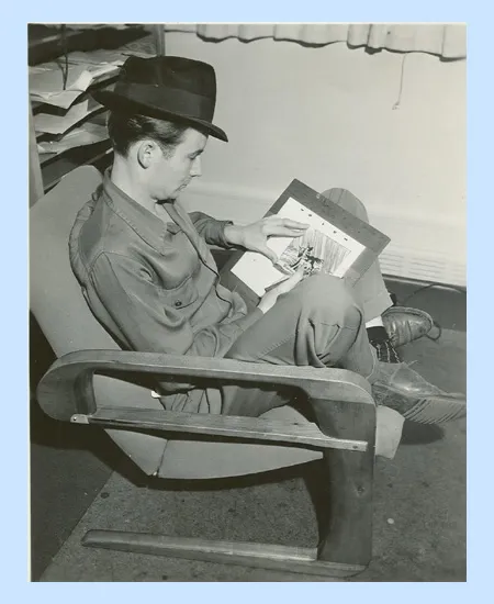 Bill Peet pretending to draw unicorns for a publicity shot