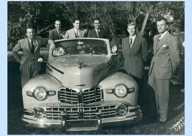 Bill Peet at left with Disney studio executives around one of Walt's new Lincolns