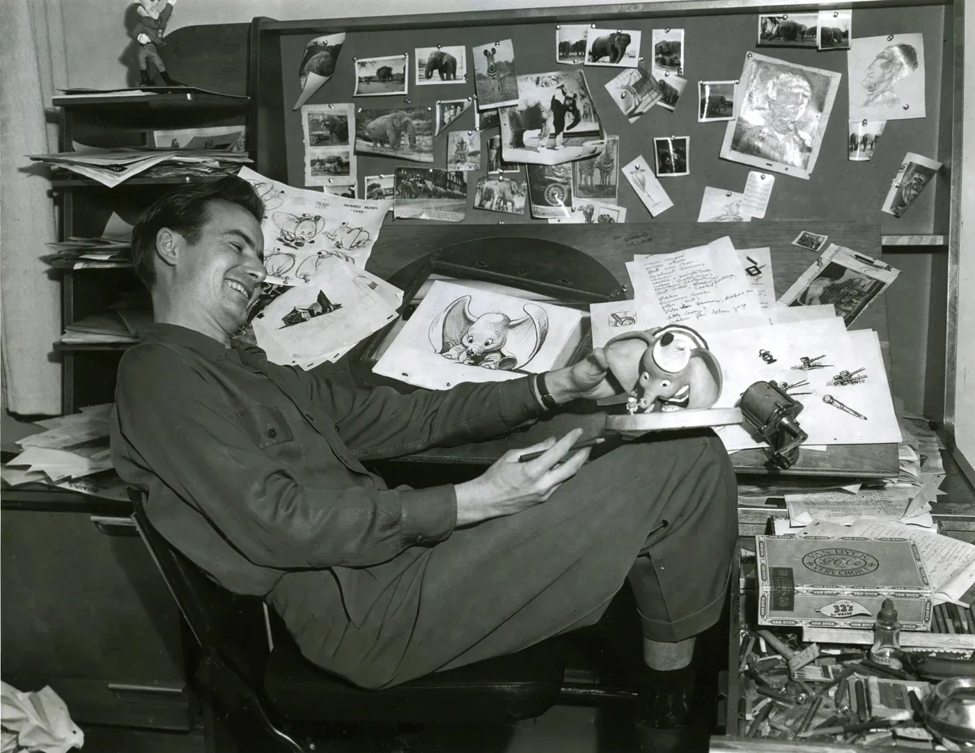 Bill Peet posing with Dumbo artwork from the film he helped shape